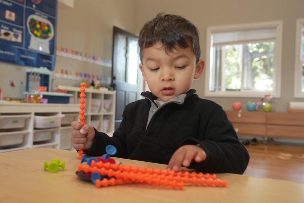 Child concentrating on building activity