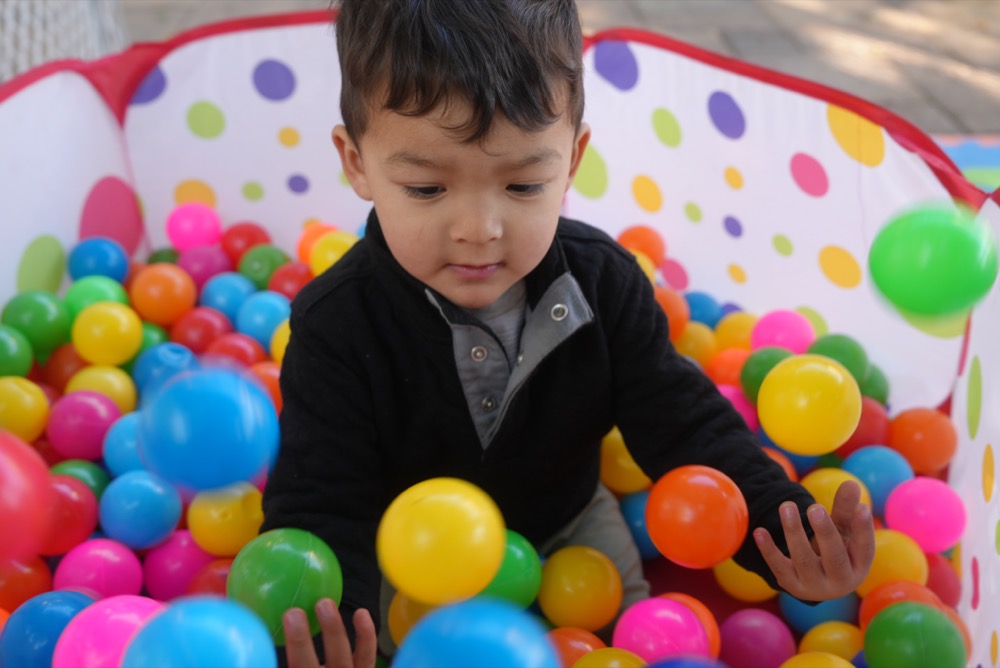 Boy having fun in the ball pit