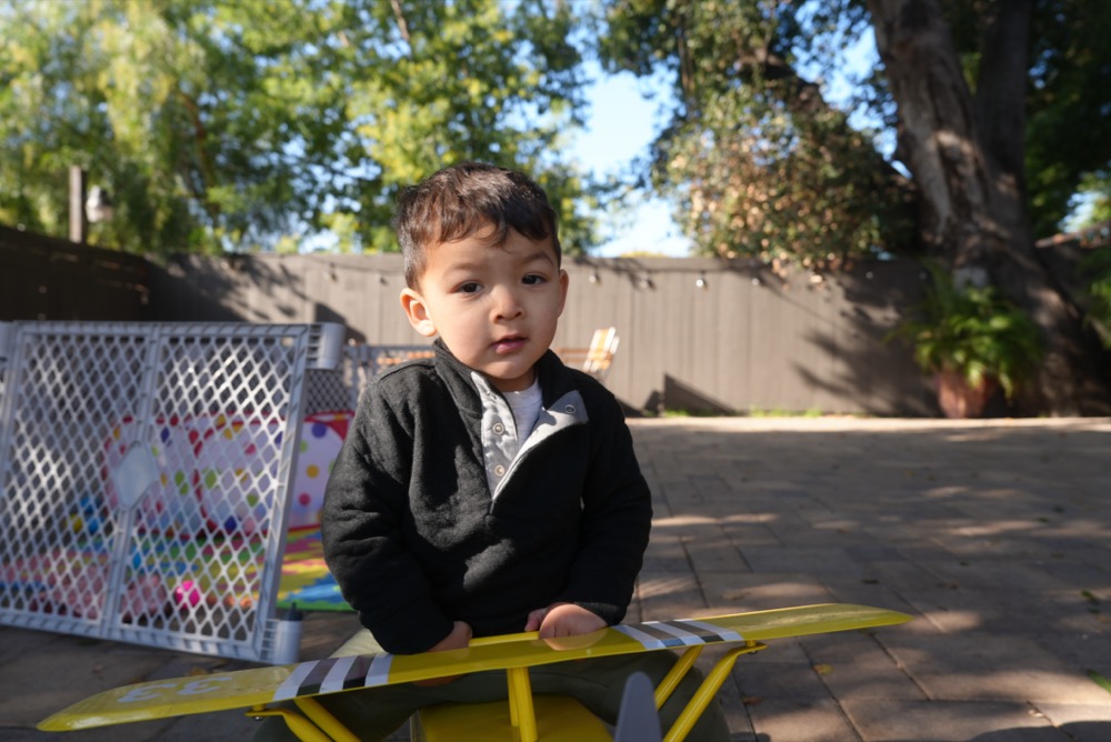 Child playing on toy airplane