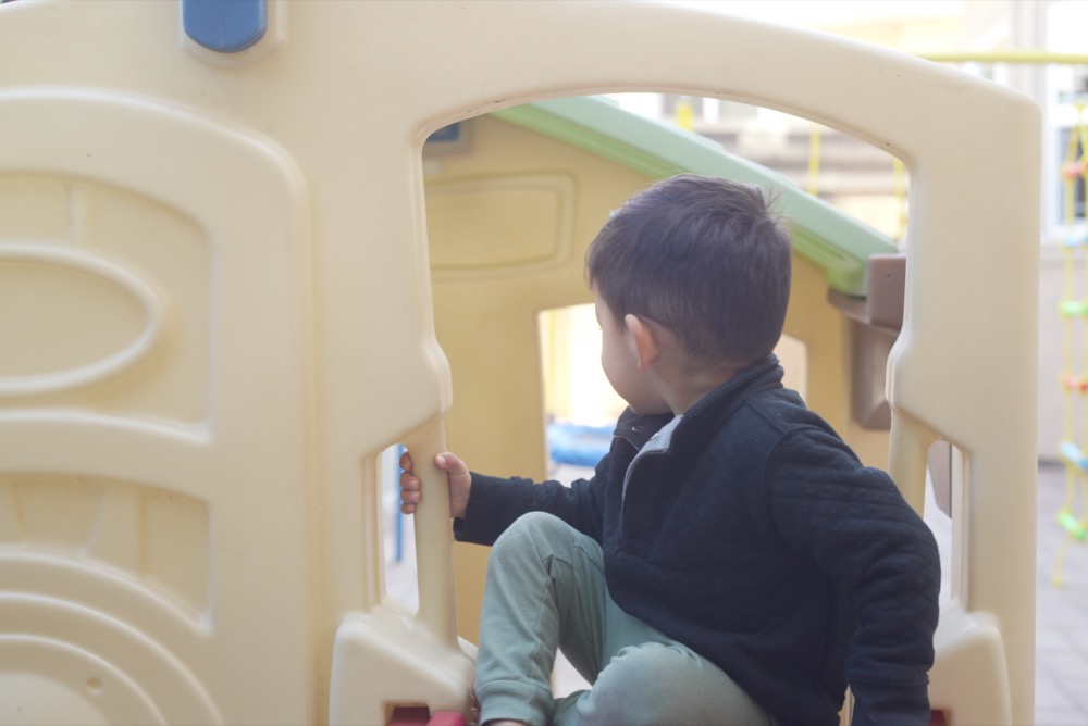 Child in the outdoor playhouse